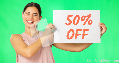 Image of Woman, portrait and sale sign on green screen advertising percentage or discount rate on paper or banner. Smile of a happy female on a studio background for promotion deal, savings or deal and offer