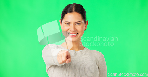 Image of Face, pointing to you and woman with green screen, inspiration and smile on studio background. Portrait, female and person with gesture for direction, show with finger and motivation with happiness