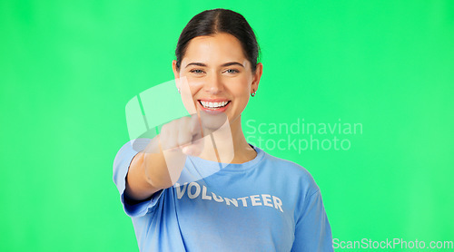 Image of Happy, woman face and volunteer with green screen of a female pointing for recruitment. Portrait, smile and female model with isolated studio background point for charity work recruit and emoji