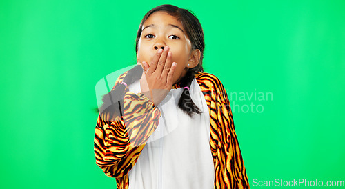 Image of Face, green screen and girl in tiger costume, surprise and hand on mouth on a studio background. Portrait, female child and young person with shock, excitement and happiness with adorable kid and wow