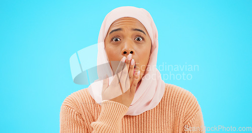 Image of Muslim woman, omg and surprise with hand on mouth for mockup, advertising or promotion. Islam female with hijab and face emoji for reaction to sale, gossip or secret on a studio blue background