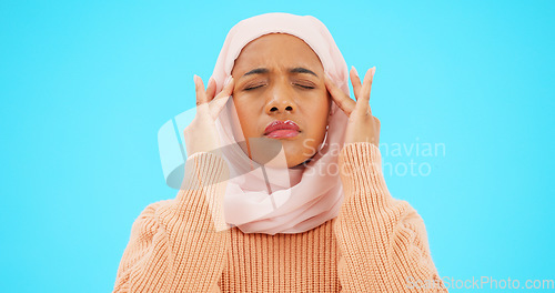 Image of Muslim woman, headache and pain in studio for depression, stress and burnout. Islamic female with hands on head for a massage or mental health in a hijab while depressed, sick and fatigue or anxiety