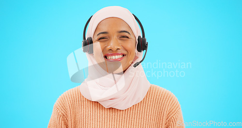 Image of Call center, woman face and isolated on blue background for agent, consultant or muslim telemarketing support. Happy telecom, technical support or communication of hijab person with headset in studio