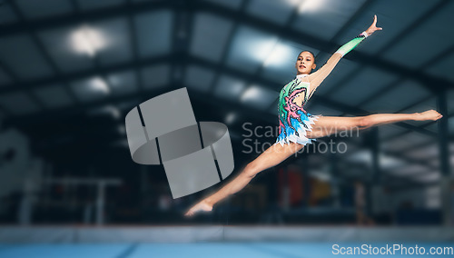 Image of Gymnastics, fitness and woman in arena jumping for sports competition, exercise and training with mockup space. Sports, movement and jump, professional gymnast with form and balance in performance.