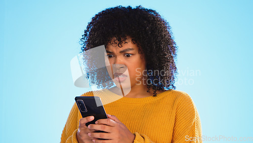 Image of Angry, smartphone and black woman shouting, stress and social media with girl against a blue studio background. African American female, moody lady and cellphone with connection, upset and screaming