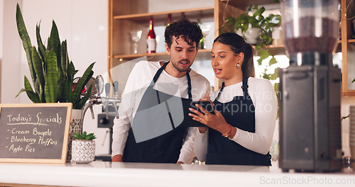 Image of Barista team, talking with tablet in coffee shop, man and woman, discussion about work schedule or inventory check. Communication, technology with online system in cafe, working and manage sales