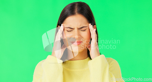 Image of Stress, frustrated and a woman with a headache on a green screen isolated on a studio background. Burnout, anxiety and a girl massaging her temples to relieve migraine pain on a mockup backdrop