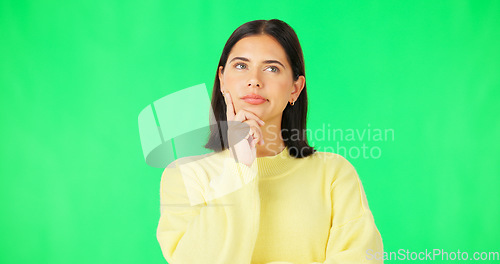 Image of Mind, thinking and decision with a woman on a green screen background in studio to consider an option. Idea, face and contemplating with an attractive young female looking thoughtful on chromakey
