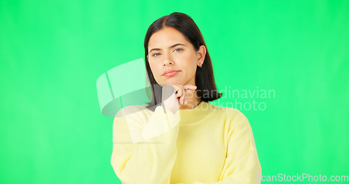 Image of Face, thinking and consider with a woman on a green screen background in studio to decide her options. Idea, mind and contemplating with an attractive young female looking thoughtful on chromakey