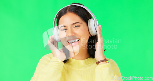 Image of Face, green screen and woman with headphones, dance and music streaming against a studio background. Portrait, female and person with headset, listening to audio and sounds for movement and smile