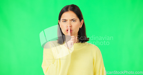 Image of Secret, green screen and face of serious woman in studio, finger and lips on background for privacy. Portrait, angry female model and silence of noise, shush on mouth and quiet for confidential emoji