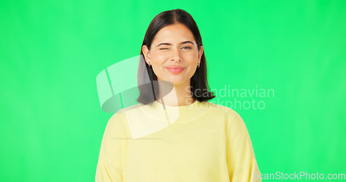 Image of Happy, woman and face wink on green screen, studio and color background. Portrait, female model and winking with smile of cool girl, fun mood and joyful personality in happiness, emoji and flirting