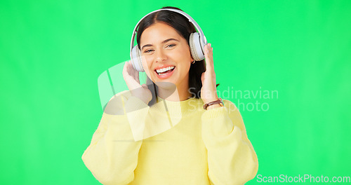 Image of Face, green screen and woman with headphones, listen and movement on a studio background. Portrait, female dancer and person with headset, streaming music and excitement with stress relief and relax