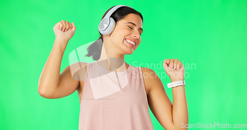 Image of Headphones, happy woman and dancing to music on green screen, studio and backdrop. Dance, female model and listening to audio album, streaming media and sound of radio, subscription podcast or energy