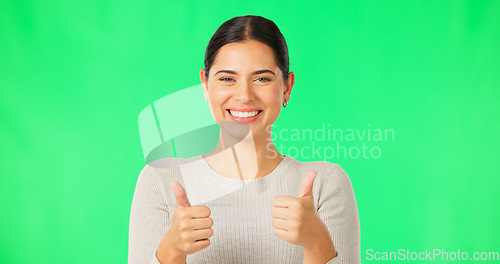 Image of Happy woman, hands and thumbs up on green screen for agreement, good job or winning against a studio background. Portrait of female smile showing thumb emoji, yes sign or like for winning on mockup