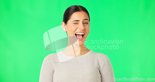 Image of Happy young woman, face and wink on green screen, studio and color backdrop. Portrait, female model and smile for blink, secret and cool girl in fun mood, personality and happiness for flirting emoji