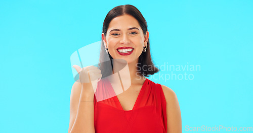 Image of Woman face, pointing and promotion with beauty and smile showing mockup for advertisement. Portrait, isolated and studio background with a happy young female point to show mock up announcement