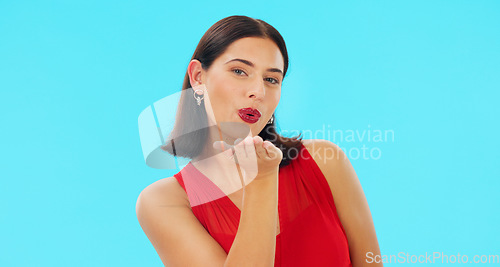 Image of Face, woman and blowing kiss on blue background, studio and color backdrop of love, care and flirting hands. Portrait of happy model, air kissing and smile for happiness, emoji or valentines day date