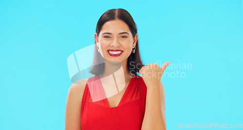 Image of Woman face, pointing and promotion with beauty and smile showing mockup for advertisement. Portrait, isolated and studio background with a happy young female point to show mock up announcement