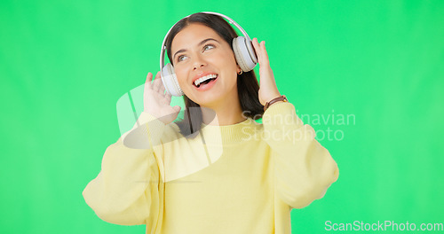 Image of Face, green screen and woman with headphones, listen and movement on a studio background. Portrait, female dancer and person with headset, streaming music and excitement with stress relief and relax