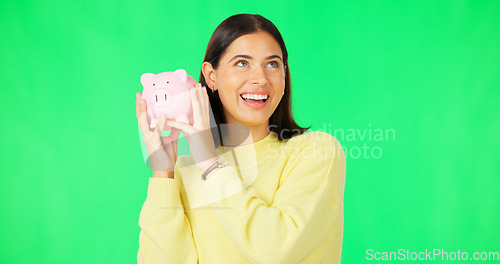 Image of Happy woman, money and savings on green screen for investment, budget or finance against studio background. Portrait of excited female smile holding piggybank for coin, profit or investing on mockup