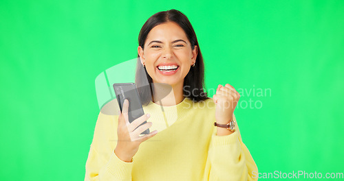 Image of Happy woman, phone and celebration on green screen for winning, promotion or bonus against a studio background. Portrait of excited female in joyful happiness on smartphone for win or prize on mockup