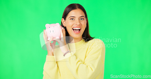 Image of Happy woman, money and savings on green screen for investment, budget or finance against studio background. Portrait of excited female smile holding piggybank for coin, profit or investing on mockup