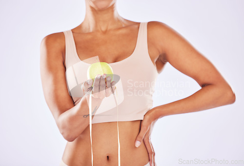 Image of Apple, health and tape measure for diet of woman in studio for healthy lifestyle, weight loss or fitness. Female on a white background for wellness and fruit motivation in hand for healthcare goals