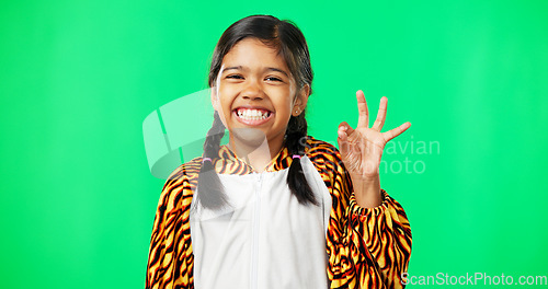 Image of Children, perfect and hand gesture with a girl on a green screen background in studio feeling good. Portrait, smile and emoji with an adorable happy female child on chromakey mockup looking positive