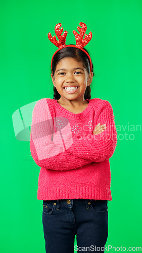 Image of Christmas, smile and happy with girl in green screen studio for positive, celebration and festive. Present, cheerful and vacation with portrait of child on background for season, holiday or happiness