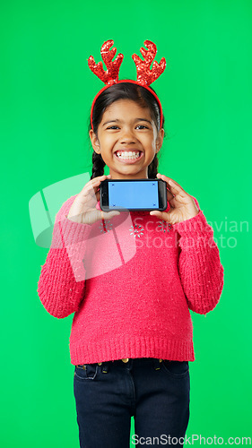 Image of Christmas face, green screen and kid with phone in studio isolated on a background with tracking markers. Mockup, xmas and smile of happy girl with mobile smartphone for marketing or advertising.