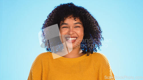 Image of Happy black woman, face and beauty in studio by blue background for fashion, smile and wellness. Young gen z student, portrait and happy with yellow clothes, curly hair afro and confident by backdrop