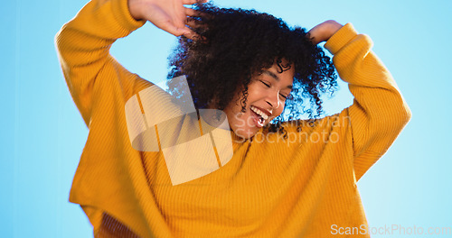 Image of Happy black woman, dance and beauty in studio by blue background for fashion, smile or wellness. Young gen z student, dancing and freedom with yellow clothes, curly hair afro and fitness by backdrop