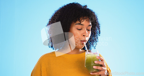 Image of Green juice, black woman drinking and healthy smoothie of a person with weight loss drink. Studio, blue background and female with vegetable, nutrition and detox fruit shake for health and wellness