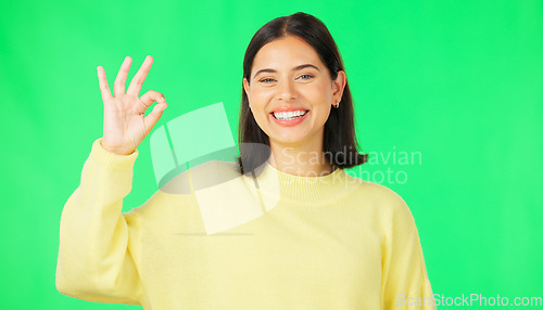 Image of Ok, green screen and portrait of woman doing a perfect sign or hand gesture isolated in a studio background. Excited, happy and female showing approval, accept and agreement signal for perfection