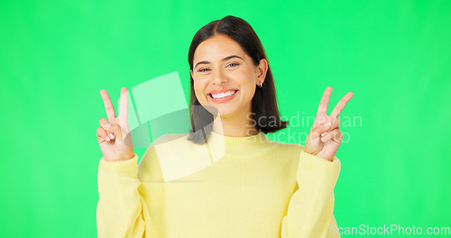 Image of Green screen, funny face expression and happy woman posing with tongue out, peace sign and carefree personality. Portrait, female model and smile in studio with emoji reactions, meme and happiness