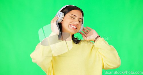 Image of Face, green screen and woman with headphones, listen and movement on a studio background. Portrait, female dancer and person with headset, streaming music and excitement with stress relief and relax