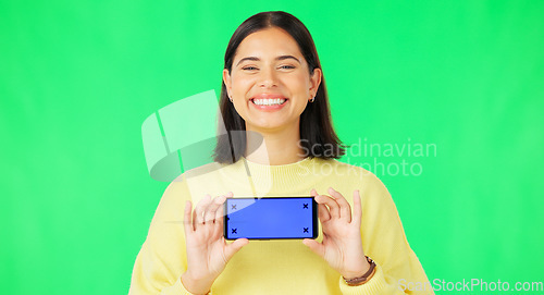 Image of Happy woman, phone and mockup on green screen with tracking markers for advertising against studio background. Portrait of female with smartphone display for advertisement or marketing on copy space