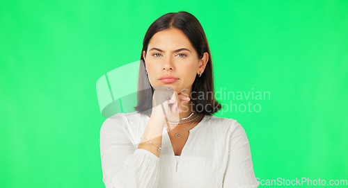 Image of Face, idea and decision with a woman on a green screen background in studio to consider an option. Thinking, mind and contemplating with an attractive young female looking thoughtful on chromakey