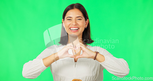 Image of Heart, hands and face of woman smile on green screen, studio or happy on studio backdrop. Portrait of female model, finger shape and love of support, thank you and emoji sign of kindness, care or joy