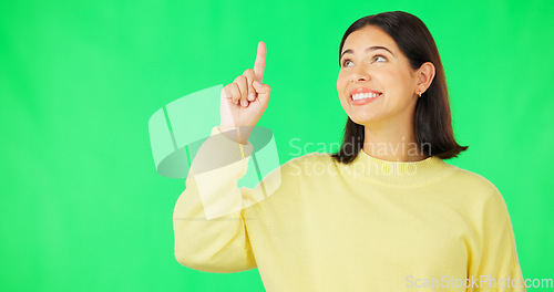 Image of Portrait, point and branding with a woman on a green screen background in studio for marketing or product placement. Hand gesture, advertising and options with an attractive young female on chromakey