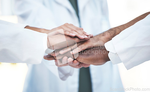 Image of Hands stacked, doctors and closeup in healthcare teamwork, solidarity and support with hospital collaboration. cooperation of medical people, staff or employees together hand sign of clinic workforce