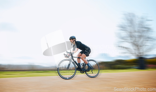 Image of Cycling, motion blur and fitness with woman in nature and mockup for speed, workout and challenge. Exercise, fast and travel with female cyclist riding on bike for journey, adventure and cardio