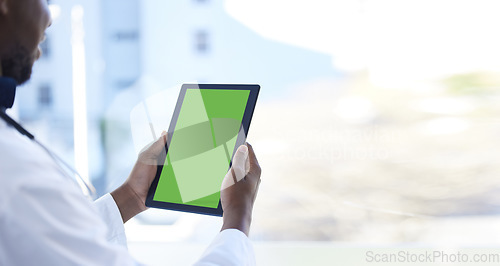 Image of Doctor, man and hands with green screen on tablet for Telehealth, healthcare or life insurance at the hospital. Hand of male medical professional holding technology with mockup or copy space display