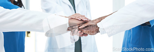 Image of Hand stack, group and doctors with teamwork, motivation and support for healthcare services at clinic. Men, women and medic team building with hands, solidarity and together at hospital for wellness