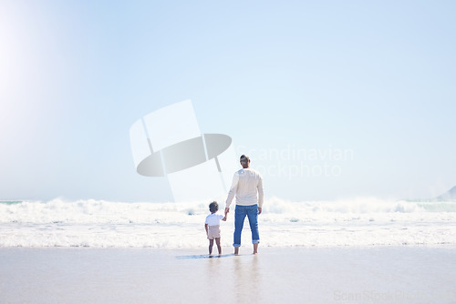 Image of Father, son and beach with back, space and mock up with blue sky, lens flare and bonding with love in summer. Papa, male kid and holding hands for care, vacation and sea mockup with waves in sunshine