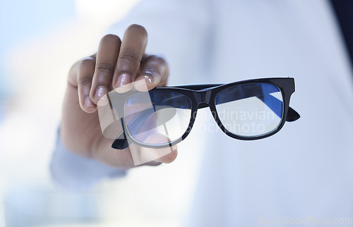 Image of Glasses, optometry and hands of a doctor for vision, eyesight checkup and giving prescription eyewear. Recommendation, help and an optometrist with eyeglasses, helping with choice and showing