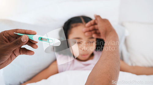 Image of Parent, hands and thermometer with sick kid checking fever or temperature for flu or cold on bed at home. Hand of adult monitoring child for illness, healthcare or virus in love, care or support