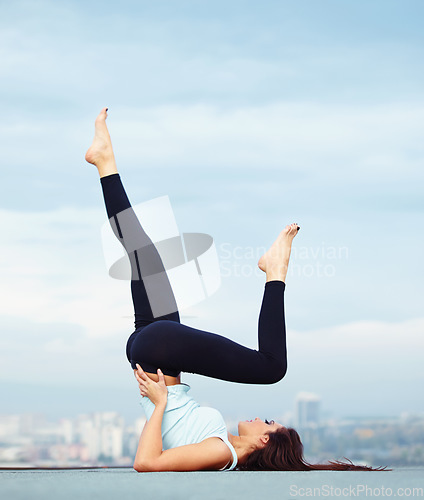 Image of Fitness, yoga and woman on roof in city, stretching legs and back for wellness and balance with healthy body. Health care, pilates and mindfulness, zen workout for girl and view of cityscape rooftop.