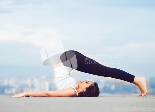Image of Fitness, yoga and stretch, woman on roof in city, stretching legs and back in wellness or body balance mockup. Health care, pilates and mindfulness, workout for girl and cityscape view on rooftop.